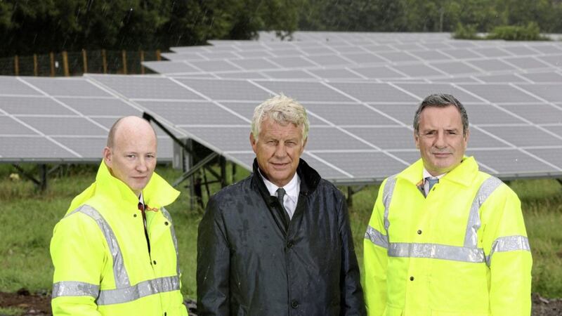Brett Martin&#39;s financial director Geoff Stewart (left) and managing director Laurence Martin with Lightsource chief executive Nick Boyle at the new solar installation in Mallusk 