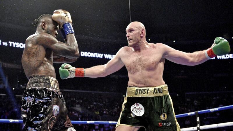 Deontay Wilder and Tyson Fury (right) during their WBC Heavyweight Championship fight in 2018