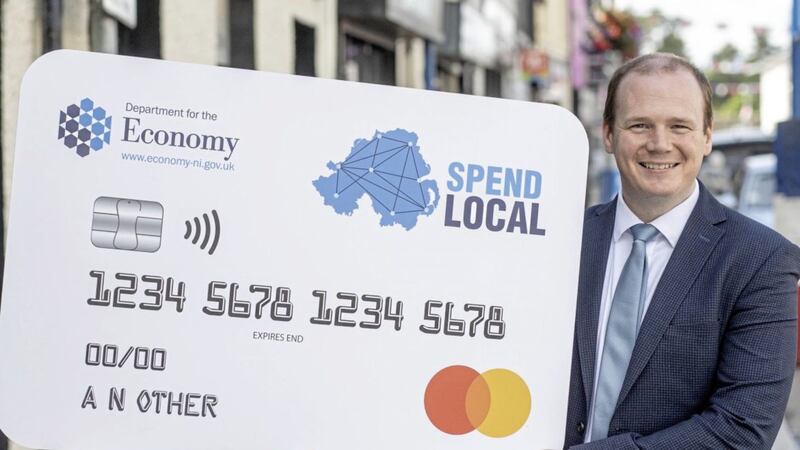 Economy Minister Gordon Lyons with a sample Spend Local card. 