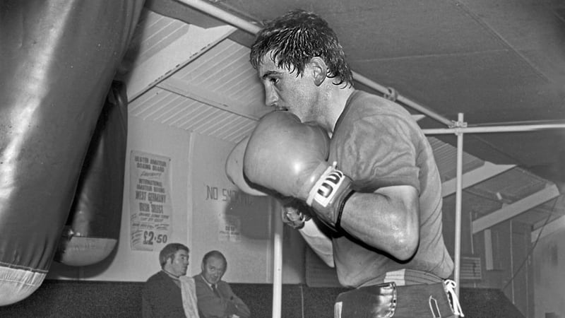 Barry McGuigan trains at the Oliver Plunkett Gym in Andersonstown while legendary trainer Eddie Shaw and manager Barney Eastwood watch in the background. 