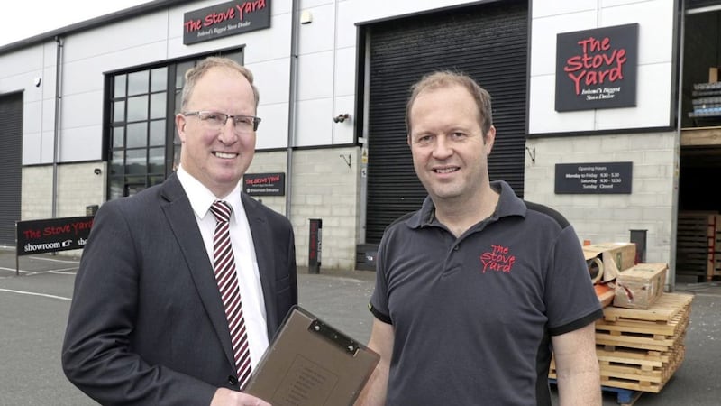 Keith Thompson, business development manager at Ulster Bank, is pictured with Richard Poulter of The Stove Yard at the company&rsquo;s new premises in Kiltonga Industrial Estate. 