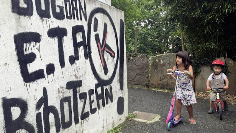 Children play by a graffiti reading &quot;ETA , Basque country and Freedom, in the memory and in the heart&quot; in Sare, southwestern France. Picture by Bob Edme, File, Associated Press. 
