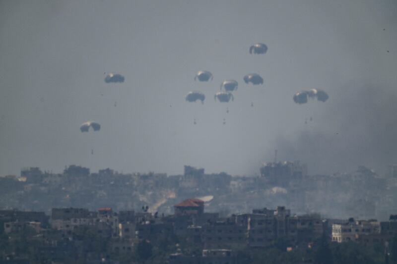 Parachutes drop supplies into the northern Gaza Strip as seen from southern Israel (Leo Correa/AP)