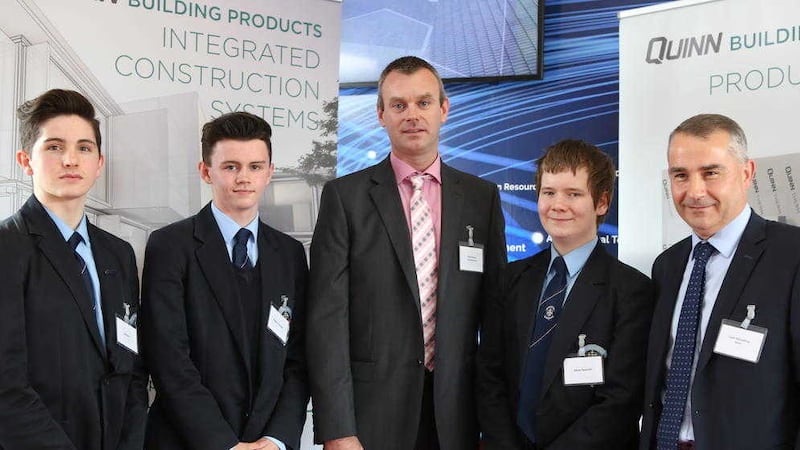 St Michael&#39;s acting principal Mark Henry (centre) pictured with students and Quinn Industrial Holdings CEO Liam McCaffrey 