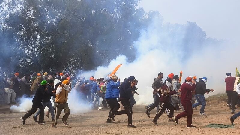 Indian police used tear gas on farmers who clashed with officers and tried to break barricades blocking their way to New Delhi to demand guaranteed crop prices (Rajesh Sachar/AP)