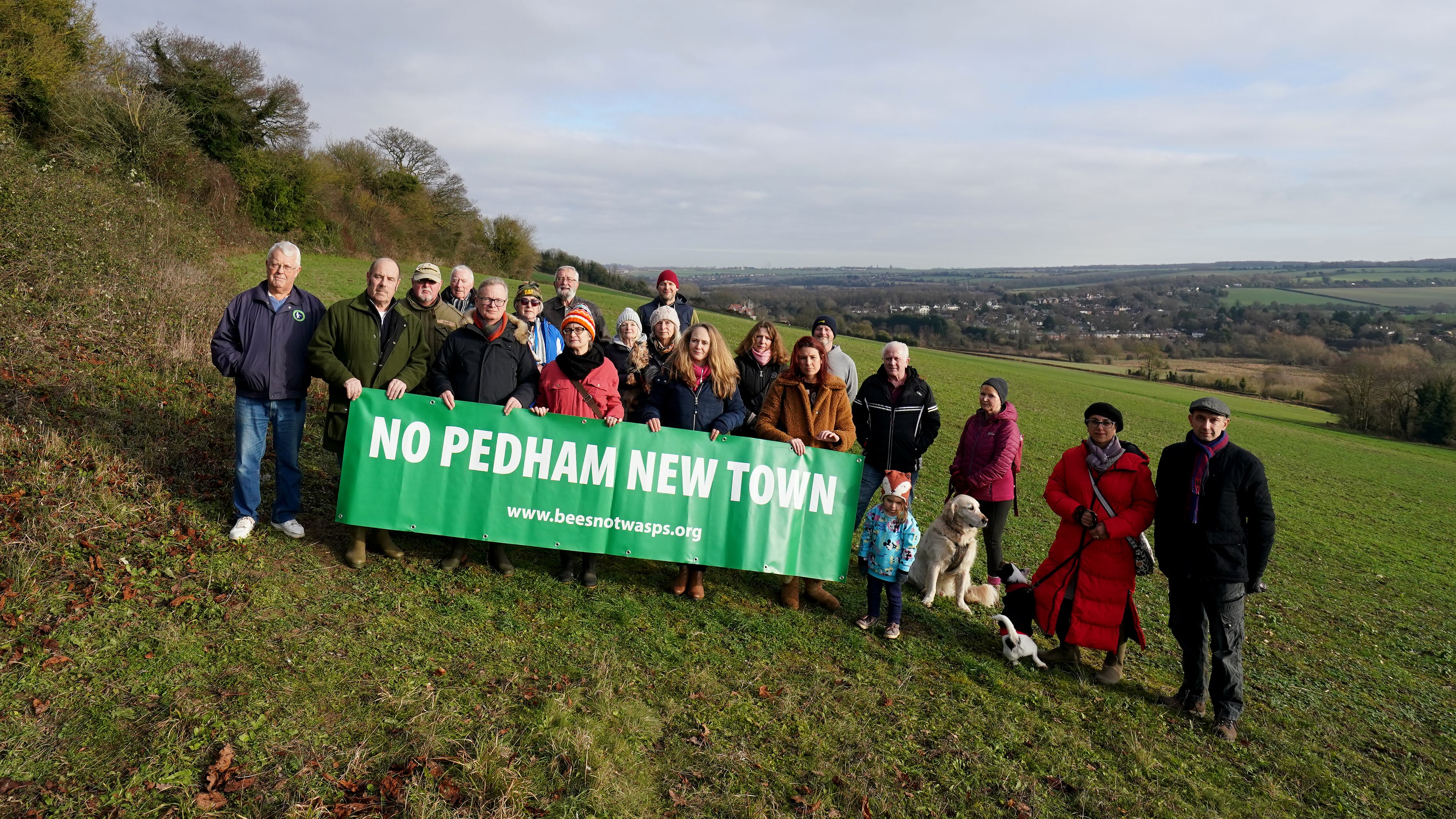 Members of the No Pedham New Town group stand near the site of a proposed garden city development at Pedham Place Golf Course in Swanley, Kent, which sits on green belt land atop of the hill above their homes in the villages of Eynsford and Farningham. Local communities are being pitted against each other “like the Hunger Games” in a planning vote over where thousands of new homes could be built on green belt land. Picture date: Thursday January 11, 2024.