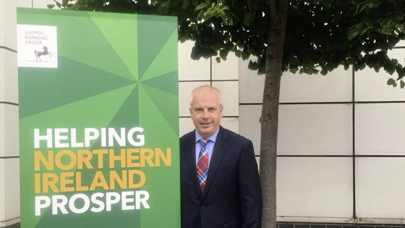 Jim McCooe with the &#39;Helping Northern Ireland Prosper&#39; banner after the Halifax Foundation handed out more than &pound;970,000 to 654 charities last year 