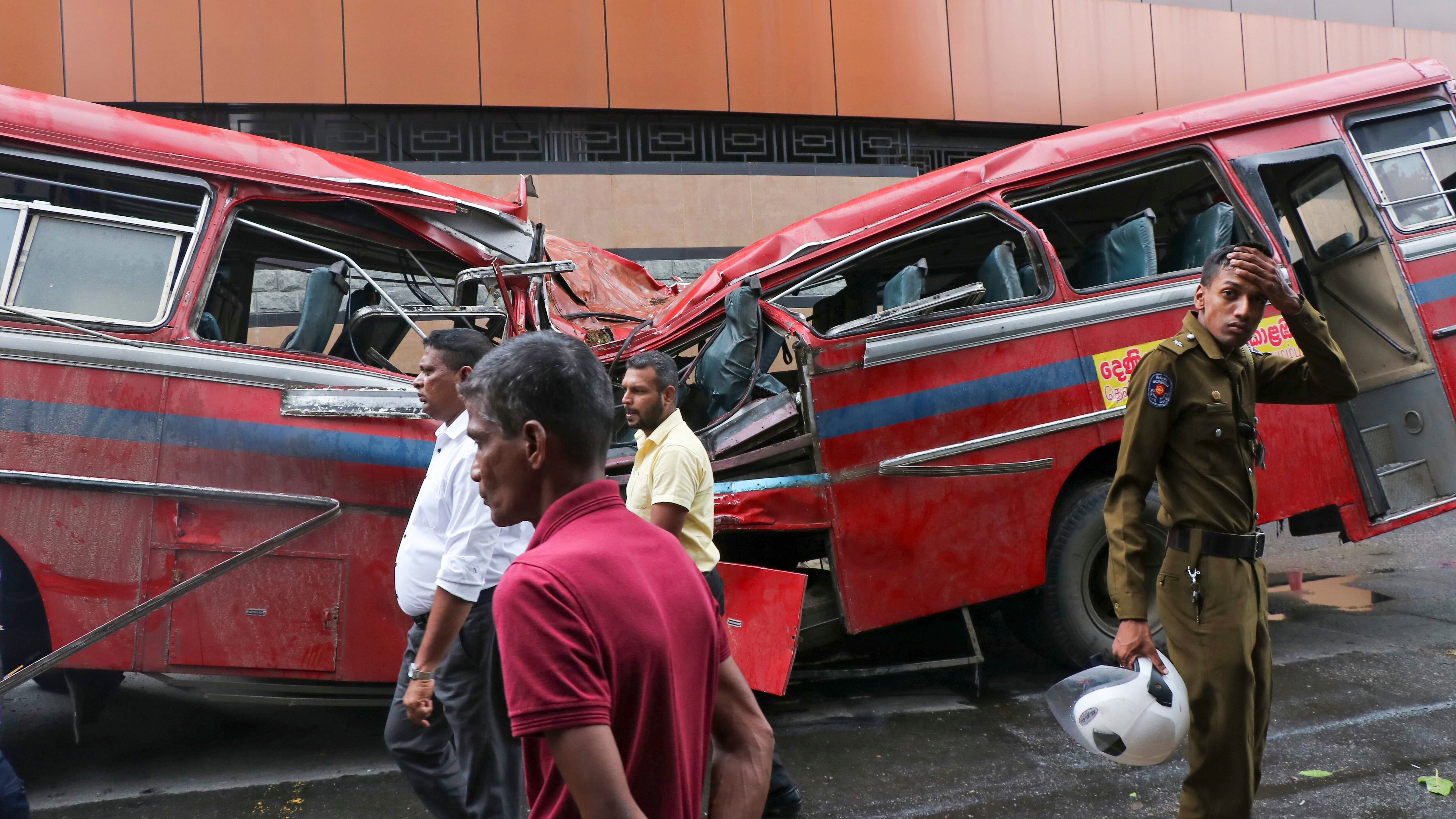 Five people were killed when a large tree toppled on to a moving bus in Colombo during heavy rain (AP Photo)
