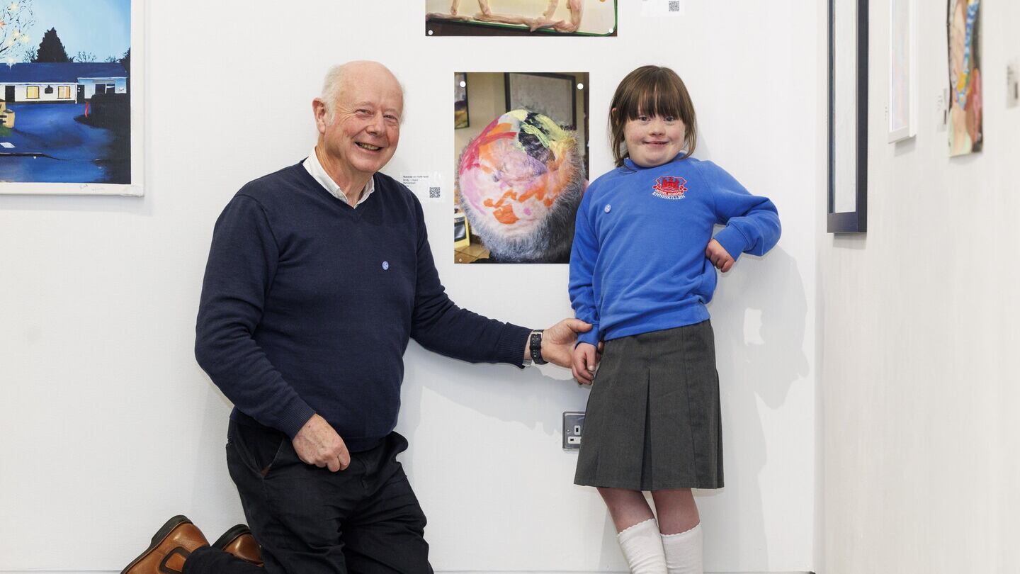 Molly Gallagher (9) from Enniskillen pictured with her dad and a photograph of her painting using her fathers head as a canvas