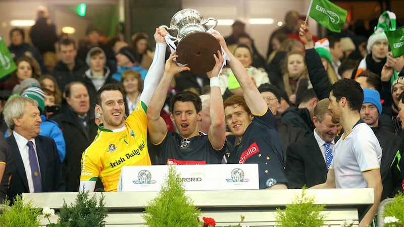 Left to right: Tyrone players Niall Morgan, Mattie Donnelly and Peter Harte lift the Cormac McAnallen Cup
