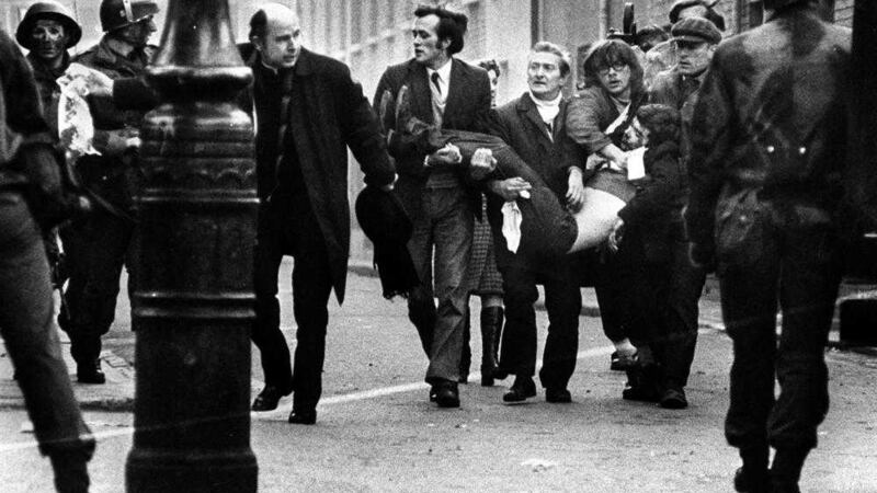 Retired bishop of Derry Edward Daly leads a group carrying the body of Jackie Duddy (17) from the Bogside on Bloody Sunday