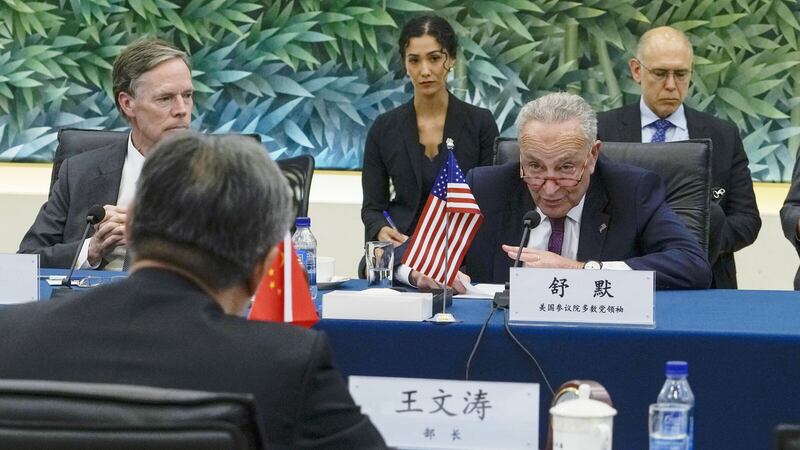 US senate majority leader Chuck Schumer talks to Chinese Commerce Minister Wang Wentao a bilateral meeting at the Ministry of Commerce in Beijing (Andy Wong/Pool/AP/PA)
