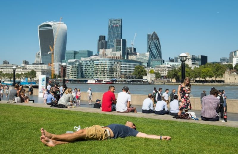 people sit outside in the hot weather in london (Dominic Lipinski/PA)