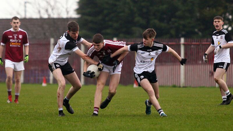 Termon's Jack Alcorn in action against Kilcoo's&nbsp; Callum&nbsp; Rogers and Niall Doyle during the Ulster Minor Football semi-final at St Paul's&nbsp; <br />Picture by S&eacute;amus Loughran&nbsp;