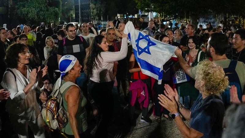 Israelis celebrate the news of the release of 13 hostages held by Hamas (AP Photo/Ariel Schalit)