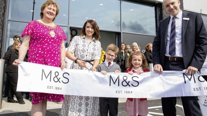 Launching the new M&amp;S store in Carrickfergus are: Mayor of Mid and East Antrim Borough Council, Maureen Morrow; store manager, Grace Lough; and head of region for M&amp;S Simon Layton. Helping to cut the ribbon are Eva Morrison and Oscar Millar from Carrickfergus Model Primary School, who were the lucky winners of a colouring competition. 