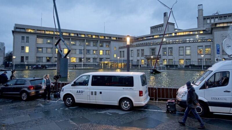Satellite trucks and cameras are set up outside the Yugoslav War Crimes Tribunal yesterday. Picture by Peter Dejong, Associated Press 