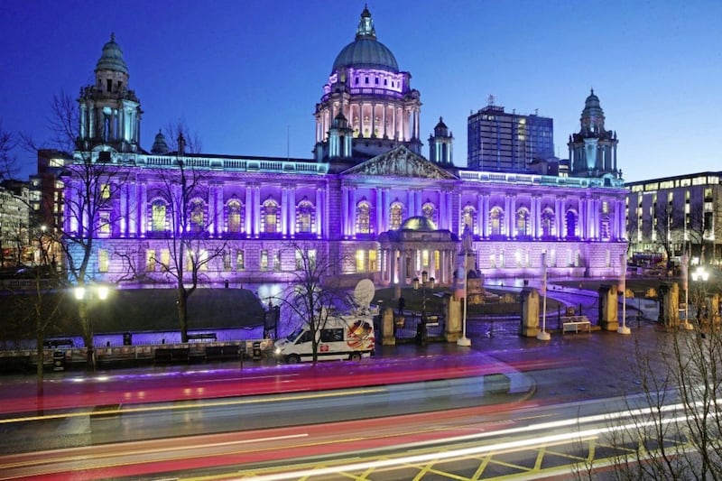 Belfast City Hall lit up green, purple and white to mark the centenary of women's suffrage