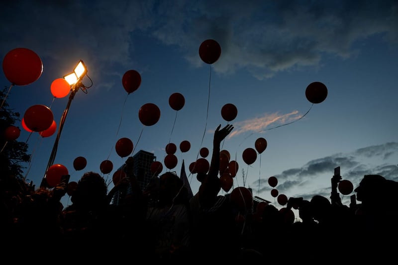 Protesters release balloons as they call for the release of the Bibas family, whose members are being held hostage in the Gaza Strip by the Hamas militant group, in Tel Aviv, Israel