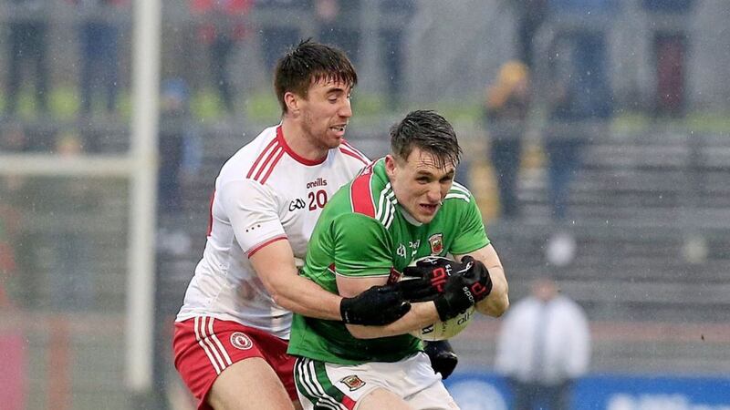 Mayo&#39;s Paddy Duran is challenged by Tyrone midfielder Conal McCann. Picture by Philip Walsh. 