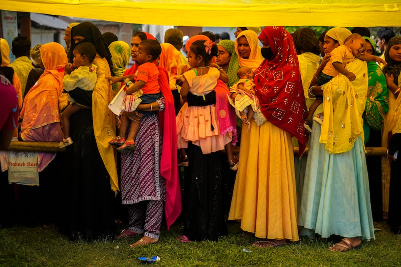 Women queue up to cast their votes in a polling station on the bank of the Brahmaputra river (Anupam Nath/AP)