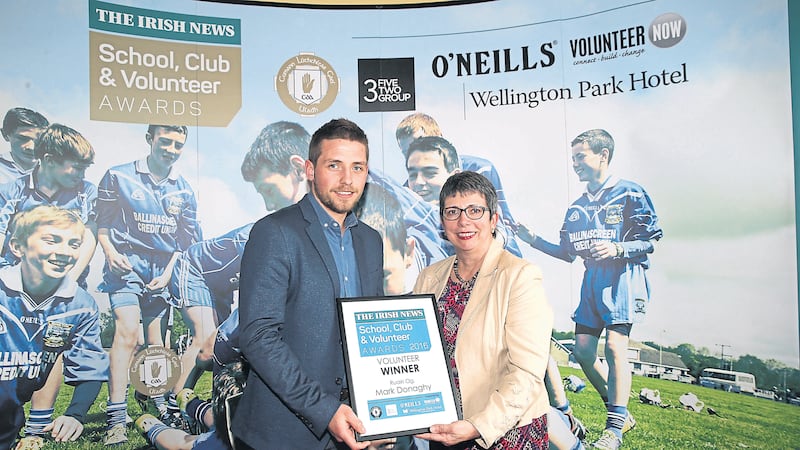 Mark Donaghy from Ruairi Og, Cushendall collecting the Young Volunteer Award from sponsor Wendy Osborne, CEO of Volunteer Now at The Irish News School, Club and Volunteer Awards<br />Picture by Hugh Russell