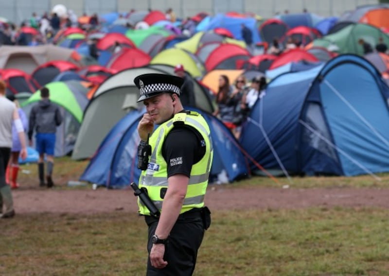 A police officer patrols in the campsite at the main stage at the T in the Park music festival at Strathallan in Perthshire.