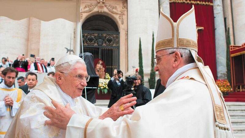 Pope Francis, right, embraces his predecessor Pope Emeritus Benedict XVI, during a ceremony in St Peter&#39;s Square at the Vatican, in 2014 in which Pope Francis made two other predecessors John XXIII and John Paul II saints 
