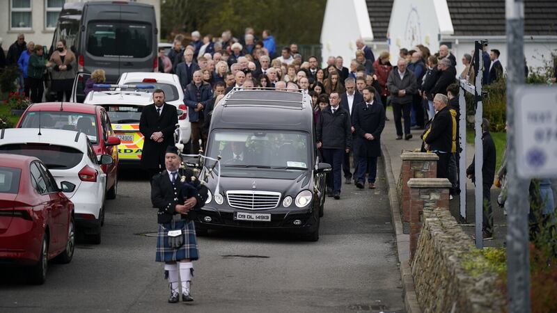A piper plays as the hearse carrying Martin McGill, 49, arrives at St Michael's Church, Creeslough, for his funeral Mass. Picture by Niall Carson/PA Wire