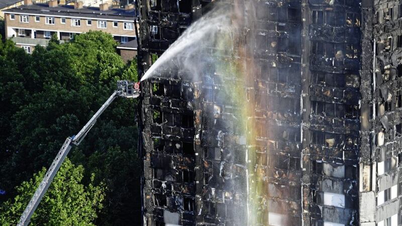 Firefighters spray water after a fire engulfed the 24-storey Grenfell Tower in west London. Picture by Victoria Jones, Press Association 