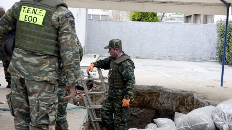 Greek army officers conduct preparation work before they excavate an unexploded World War II bomb which was found 5 meters (over 16 feet) deep, at a gas station in Thessaloniki, Greece. Picture by Giannis Papanikos, Associated Press 