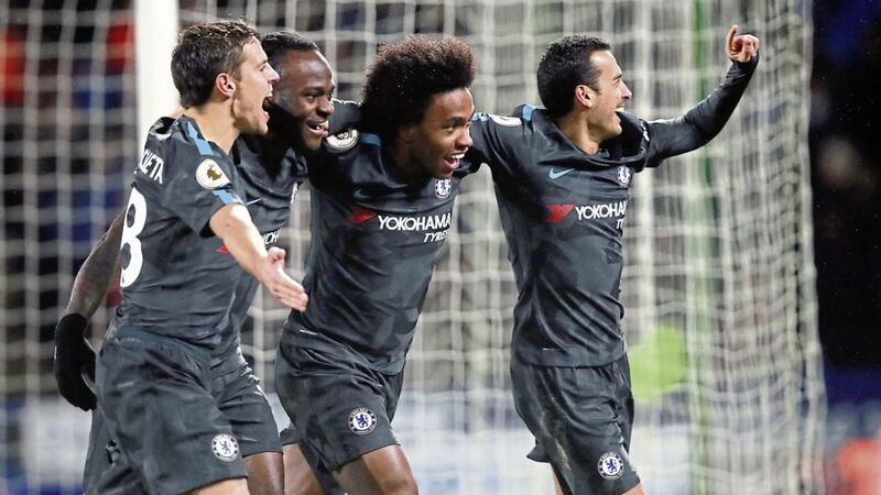 Pedro (right) celebrates scoring Chelsea's third goal against Huddersfield
