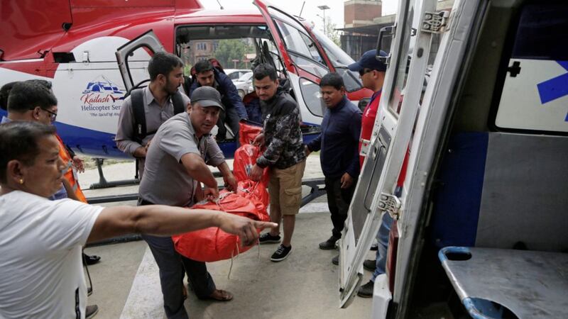 Hospital officials prepare to unload a body at the hospital. Picture by Niranjan Shrestha/AP 