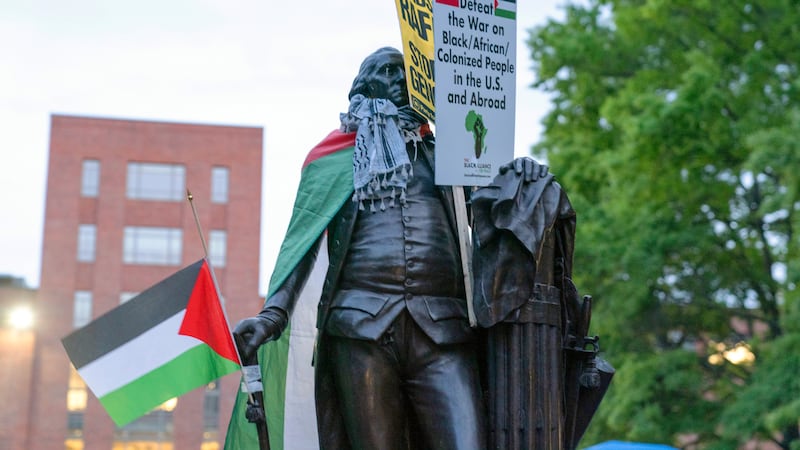 A statue of George Washington is seen with a Palestinian flag during a rally at George Washington University during a pro-Palestinian protest over the Israel-Hamas war (Jose Luis Magana/AP)