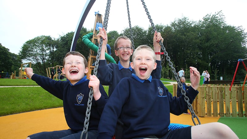 Ryan, Thomas and Darwin Pupils from Tor Bank Special School enjoy the opening of the Mo Mowlam Play Park on the Stormont Estate. Picture by Mal McCann 