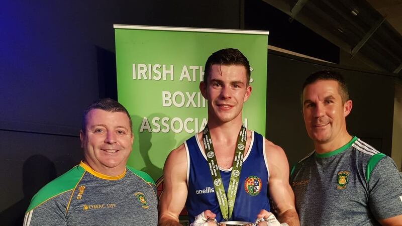 Holy Family, Drogheda welterweight Eugene McKeever celebrates his Irish Elite title success with coaches Martin McQuillan (left) and Damien McKenna