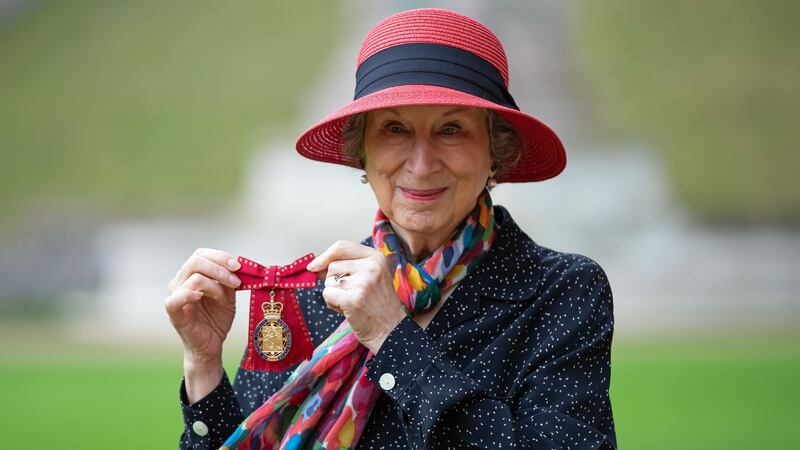The Canadian writer was presented with an Order of the Companions of Honour by the Queen.