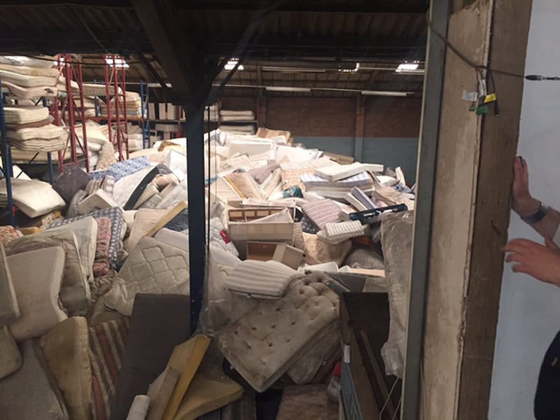 Discarded mattresses at a recycling centre.