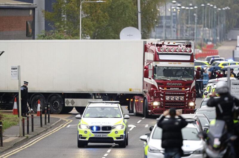 The container lorry where 39 people were found dead inside leaves Waterglade Industrial Park in Grays, Essex, heading towards Tilbury Docks under police escort on Wednesday. Picture by Aaron Chown, Press Association 