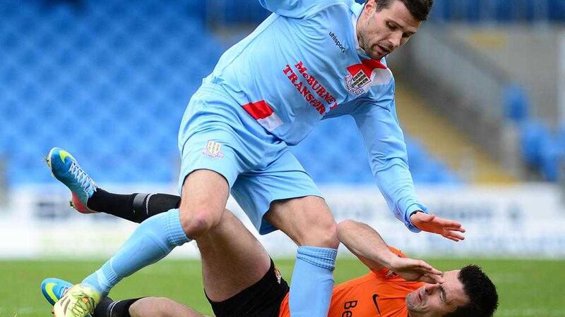 Alan Davidson tangles with Glenavon and Derry star Eoin Bradley while playing for Ballymena in 2014 before quitting soccer to concentrate on Gaelic Football. 