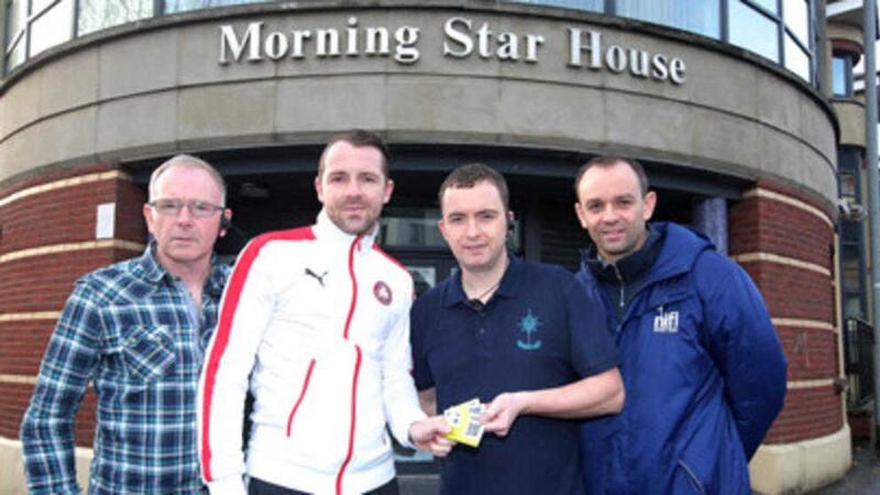 Cliftonville player Marc Smyth hands season tickets over to Emmanuel Strong and Paddy McKeown from Morning Star House, with Graeme Beggs from the NI Football League 