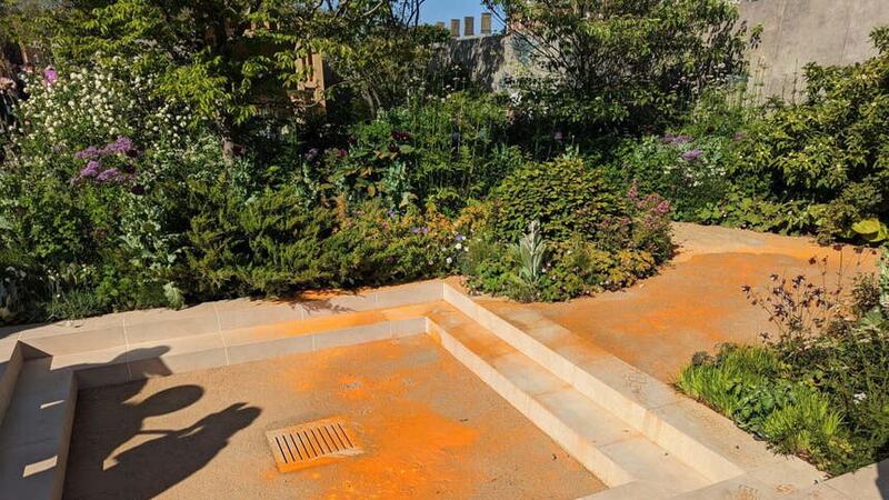 Orange paint was splashed across the garden (@MetPoliceEvents/Twitter/PA)