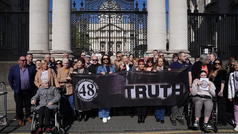 Families of the survivors and victims of the Stardust gather outside Government Buildings in Dublin