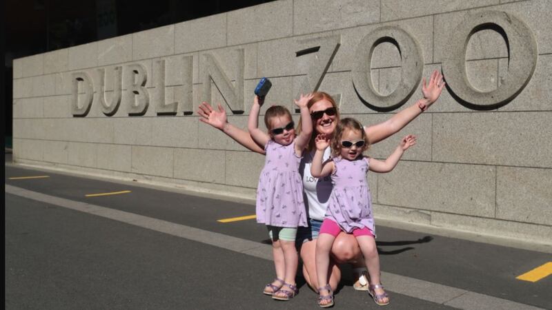 Leah Hehir (centre) with her twin three-year-old daughters Riona (left) and Meabh, who were among the first arrivals at Dublin Zoo. Picture by Niall Carson, Press Association