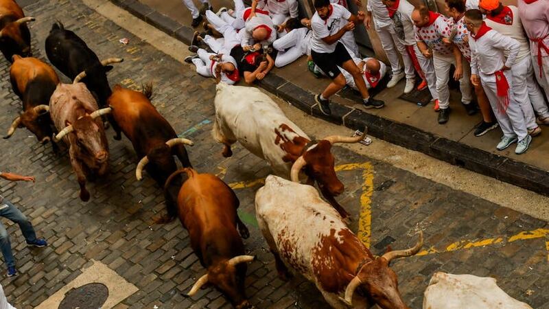 People avoid the bulls in Pamplona (Alvaro Barrientos/AP)