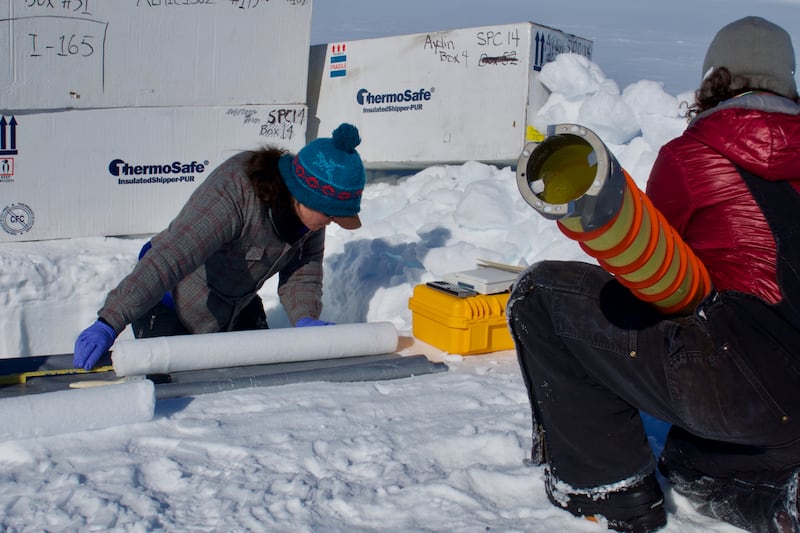 Researchers drill and measure ice cores in the Actic