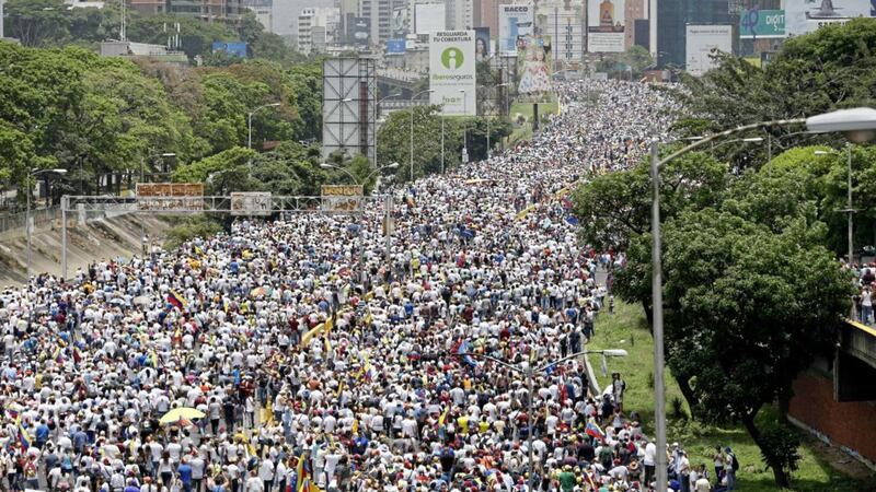 Anti-government protesters march along a highway in Caracas, Venezuela, last week 