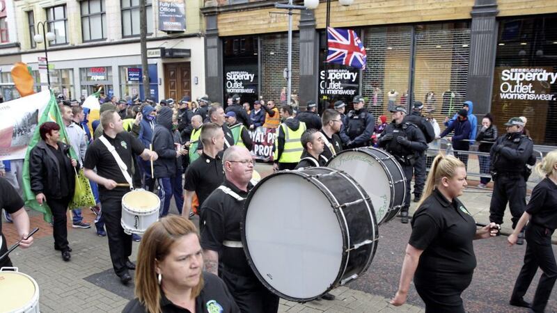 Republicans march past loyalist protsters in Belfast city centre in April last year 