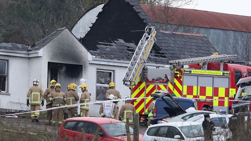 Forensic and fire officers at a house in Derrylin, Fermanagh (Brian Lawless/PA)
