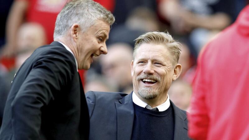 Manchester United caretaker manager Ole Gunnar Solskjaer speaks to United legend Peter Schmeichel (right) in February this year 